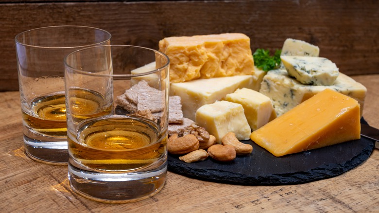 two glasses of Scotch and a cheese platter