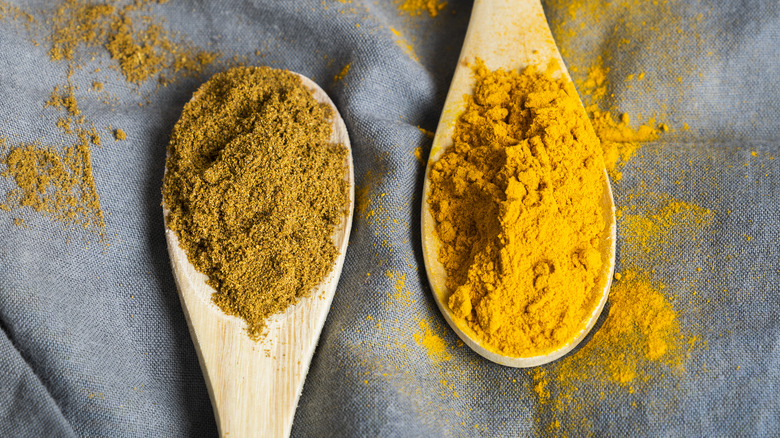 yellow powders in wooden spoons