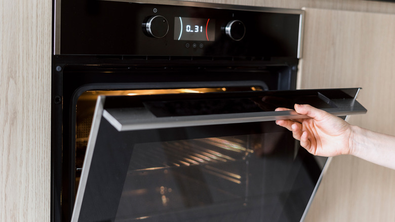 Person opening oven door