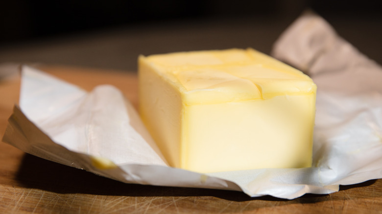 Open block of butter on foil packaging