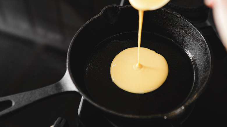 Pancake batter being poured into pan