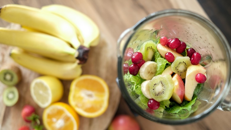 Blender filled with ingredients for a smoothie