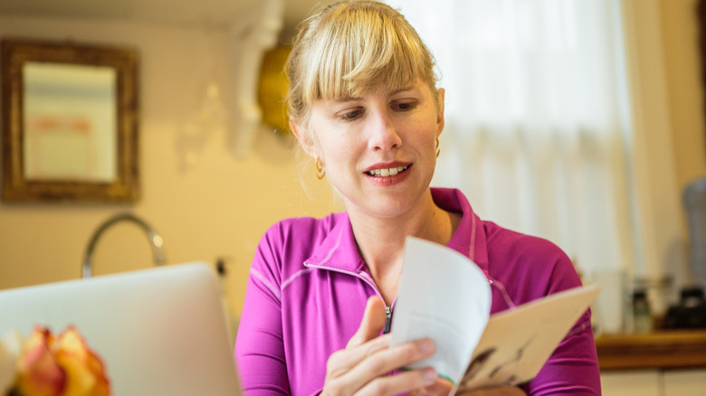 woman reading instruction booklet