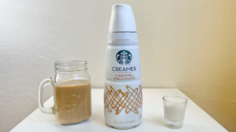 Starbucks Caramel Macchiato Creamer in bottle, shot glass, and jar of coffee