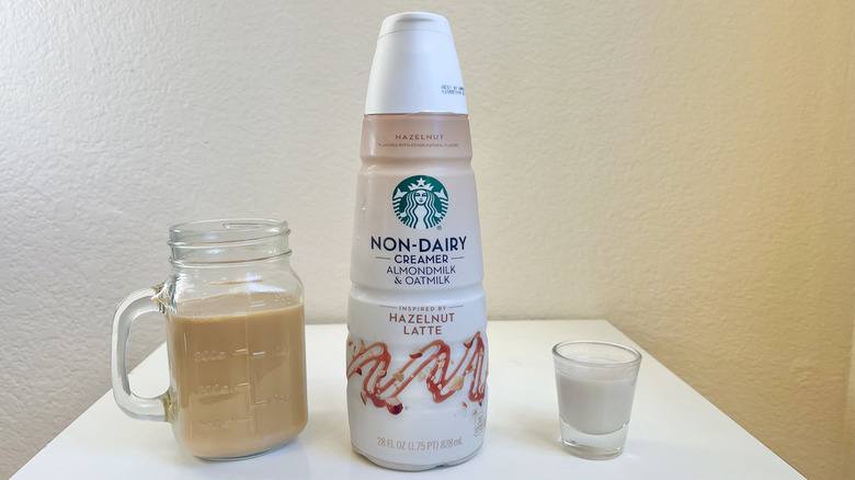 Starbucks Hazelnut Latte Non-Dairy Creamer in bottle, shot glass, and in jar of coffee