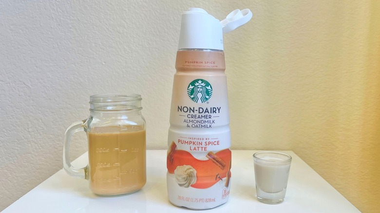 Starbucks Pumpkin Spice Latte Non-Dairy Creamer in bottle, shot glass, and jar of coffee