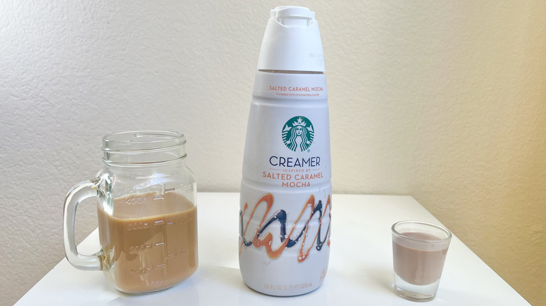 Starbucks Salted Caramel Mocha Creamer in bottle, shot glass, and jar of coffee