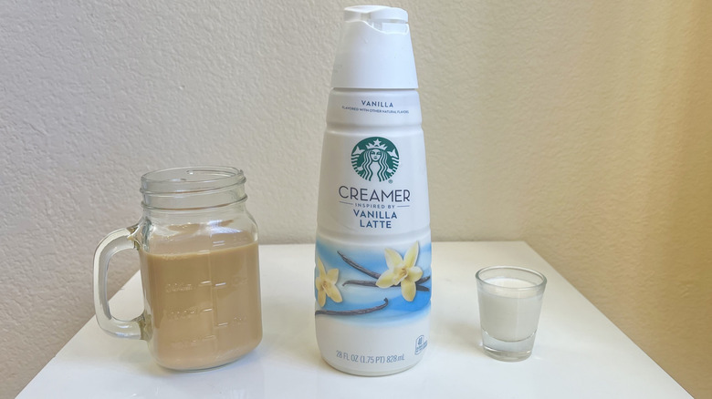 Starbucks Vanilla Latte Creamer in bottle, shot glass, and in jar of coffee