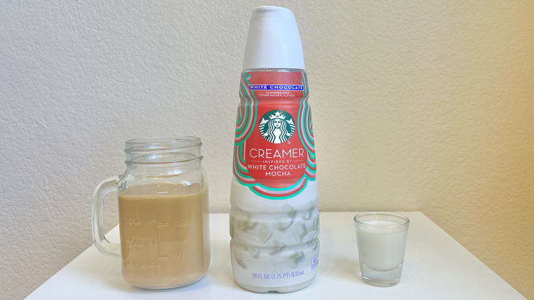 Starbucks White Chocolate Mocha Creamer in bottle, shot glass, and in jar of coffee