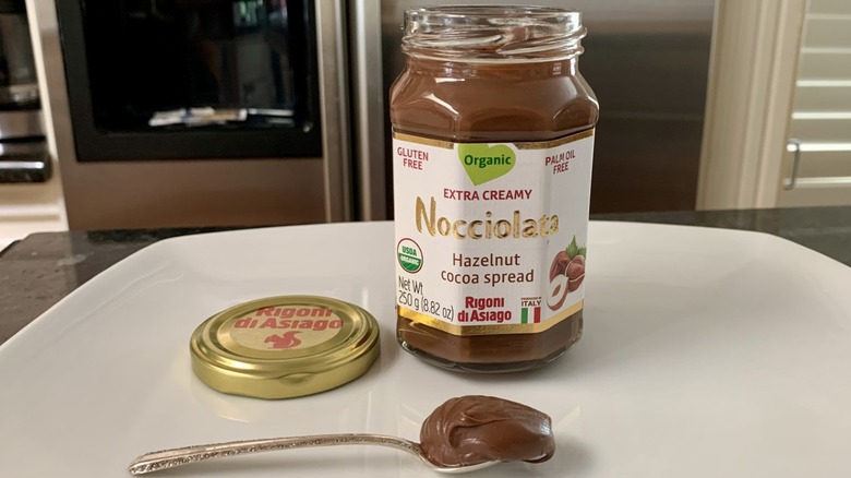 Opened container of Nocciolata Organic Hazelnut Spread with spoonful of it