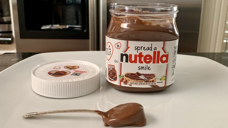 Nutella Hazelnut Spread with Cocoa container with spoonful of it