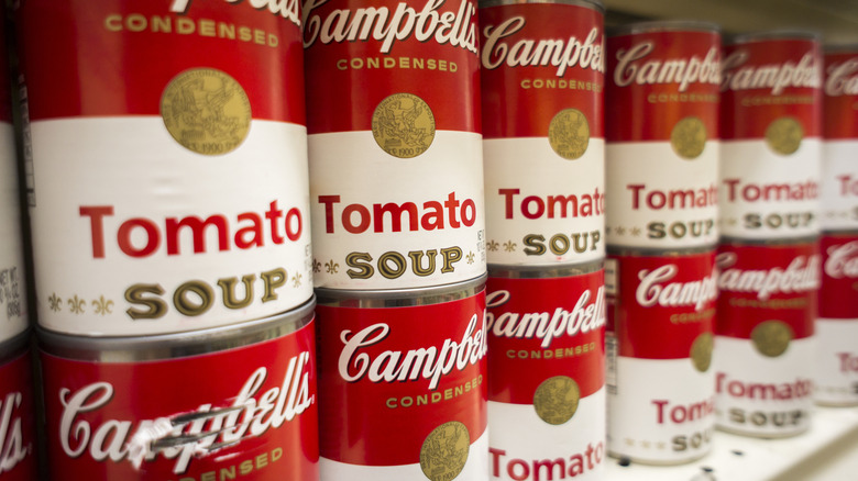 Cans of Campbell's tomato soup on a shelf