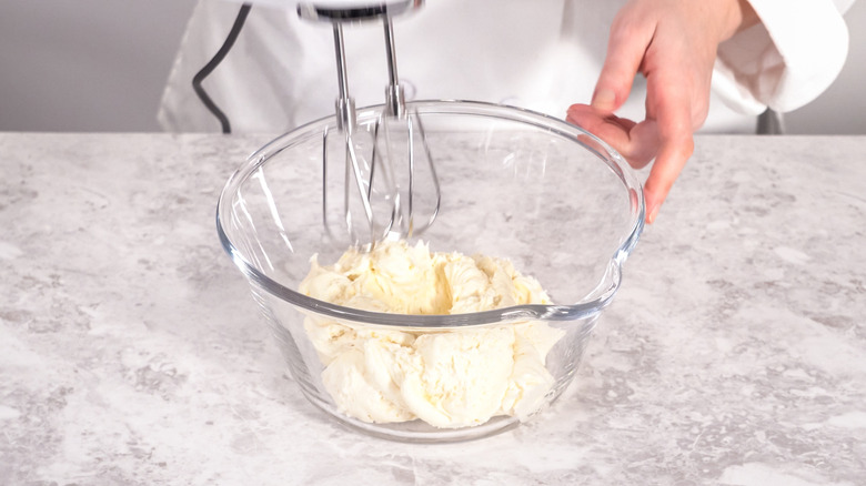 Whipping store-bought frosting with electric mixer