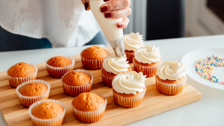 Decorating cupcakes with piping bag