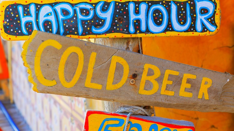 Colorful wooden happy hour sign