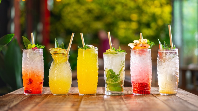 Six colorful cocktails lined up