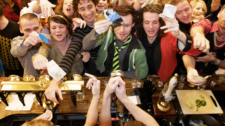 Patrons crowded around busy bar