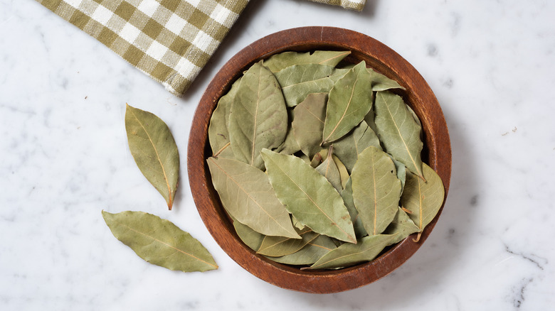 Wooden bowl of dried bay leaves