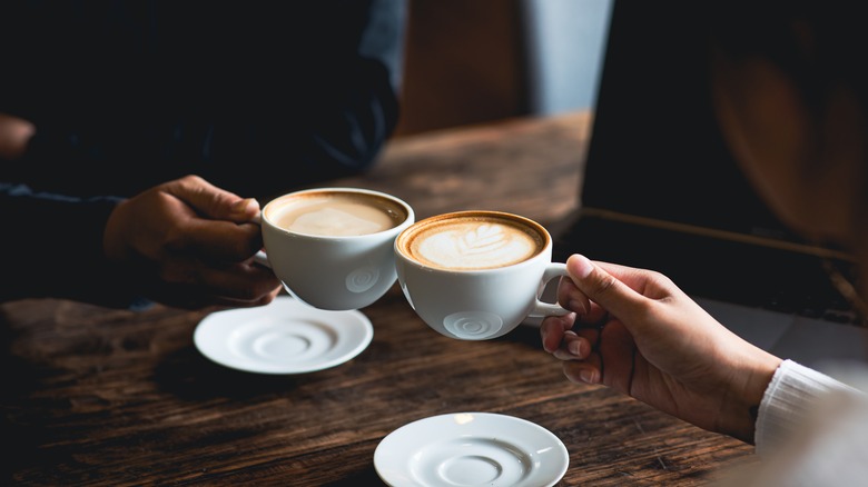 People toasting with coffee cups