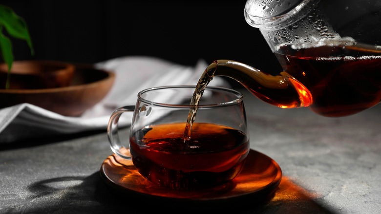 Concentrated black tea being poured into a cup