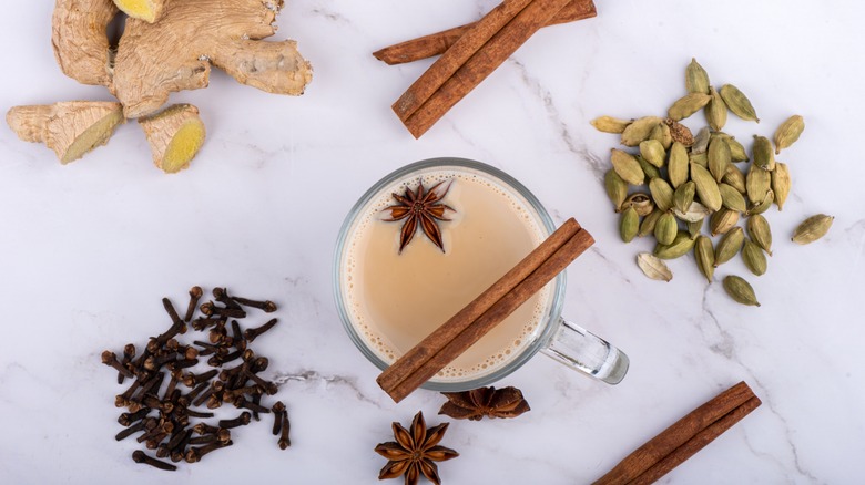 Whole chai spices and a chai tea latte