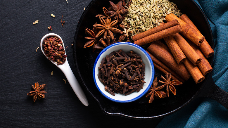 Whole chai spices in a cast iron pan