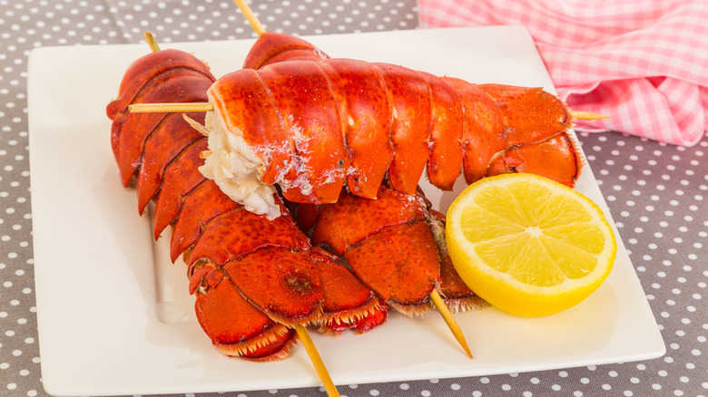 Skewered lobster tails on plate