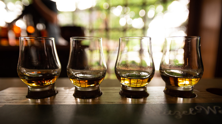 four bourbon glasses lined up