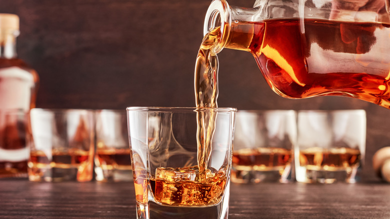 pouring bourbon in glasses