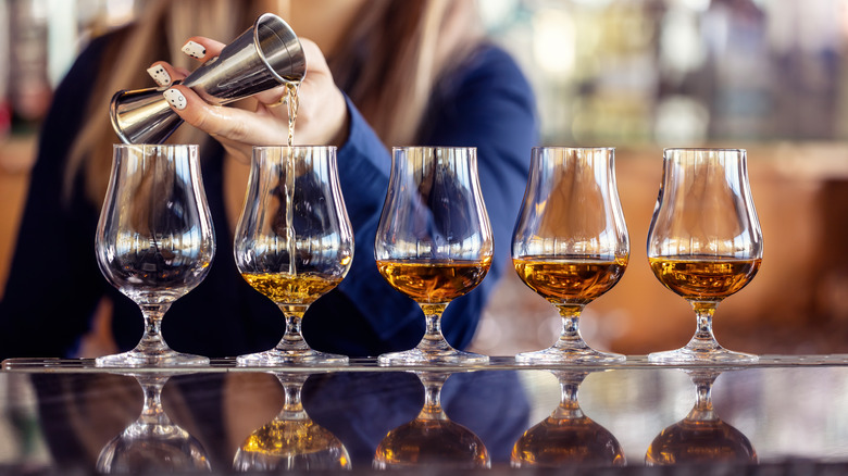 bartender pouring bourbon samples