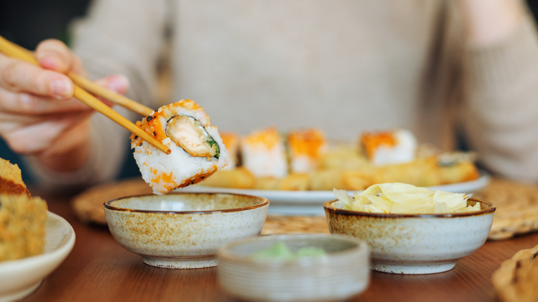 sushi getting dipped into bowl