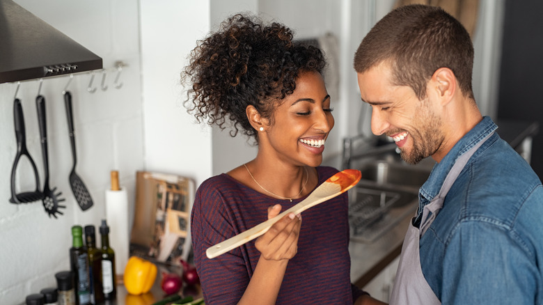 couple tasting sauce