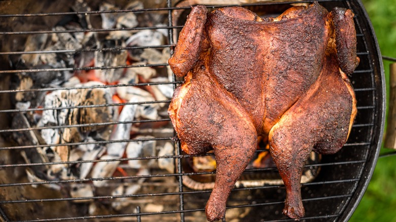 spatchcocked chicken on charcoal grill