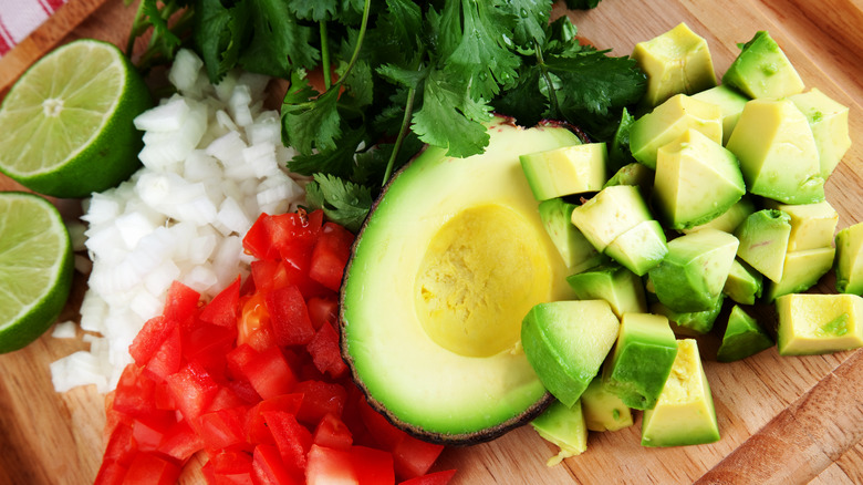 Avocado cilantro and tomatoes wood block