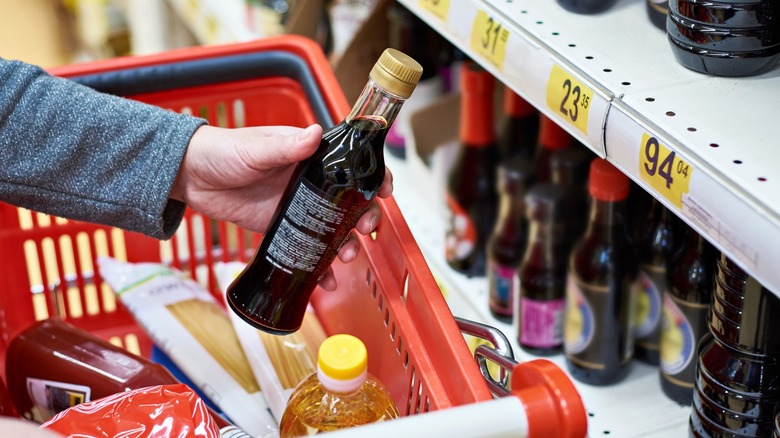 Person shopping for sauce