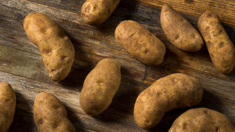 Russet potatoes on wood