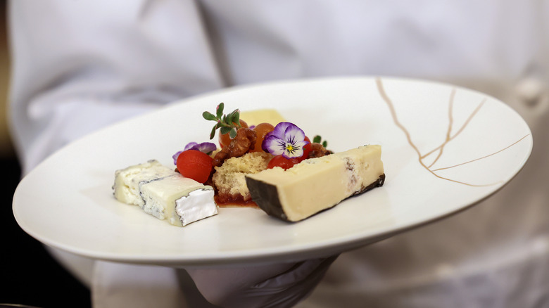 chef holding gourmet cheese plate