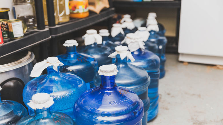 Blue 5-gallon water bottles in food storage area