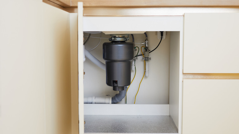 A garbage disposal under a sink