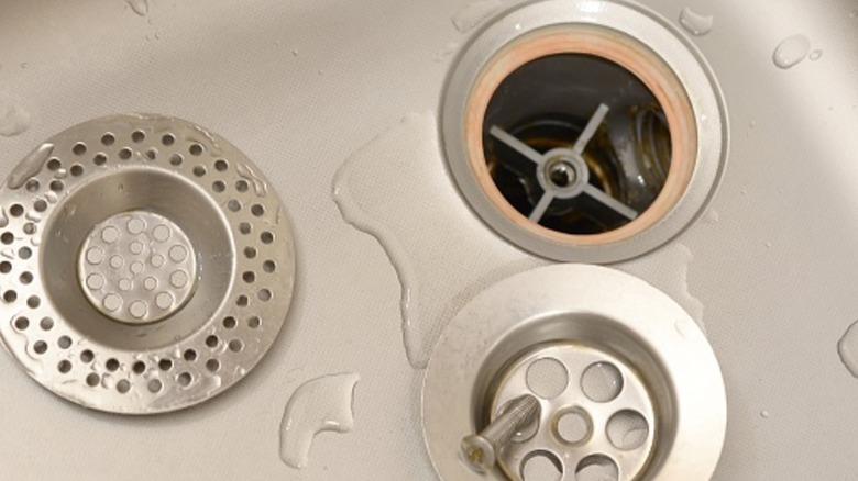 An empty kitchen sink with drain parts