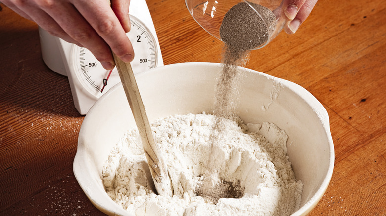 adding yeast to flour