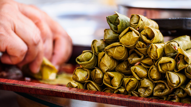 hand rolling dolmas pile 