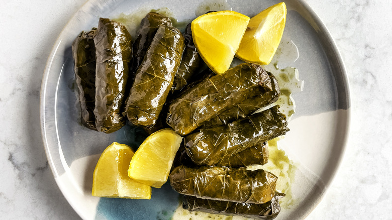 plate cooked dolma lemon wedges 