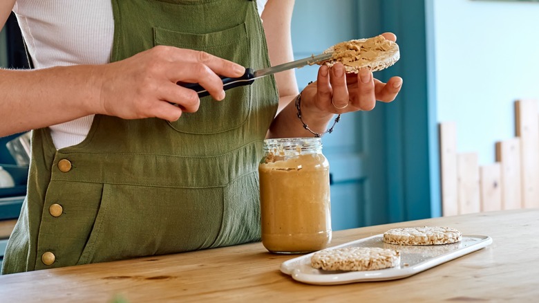 woman spreading peanut butter