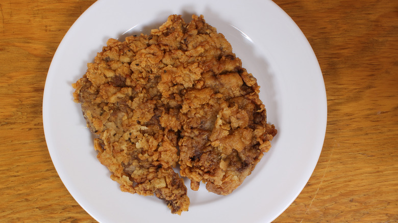 Plain chicken fried steak on white plate