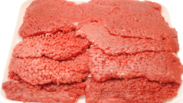 Tray filled with several raw cube steaks