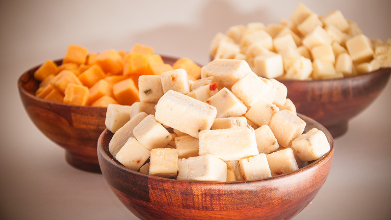 Three bowls of various cheeses