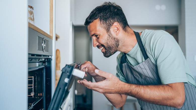 man opening oven 