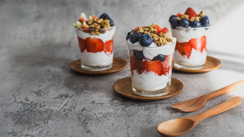 Colorful parfaits on wooden plates