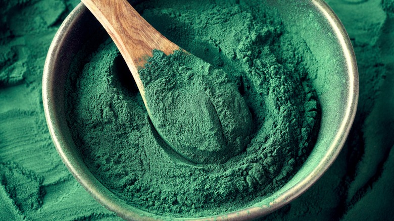 Spirulina powder with wooden spoon